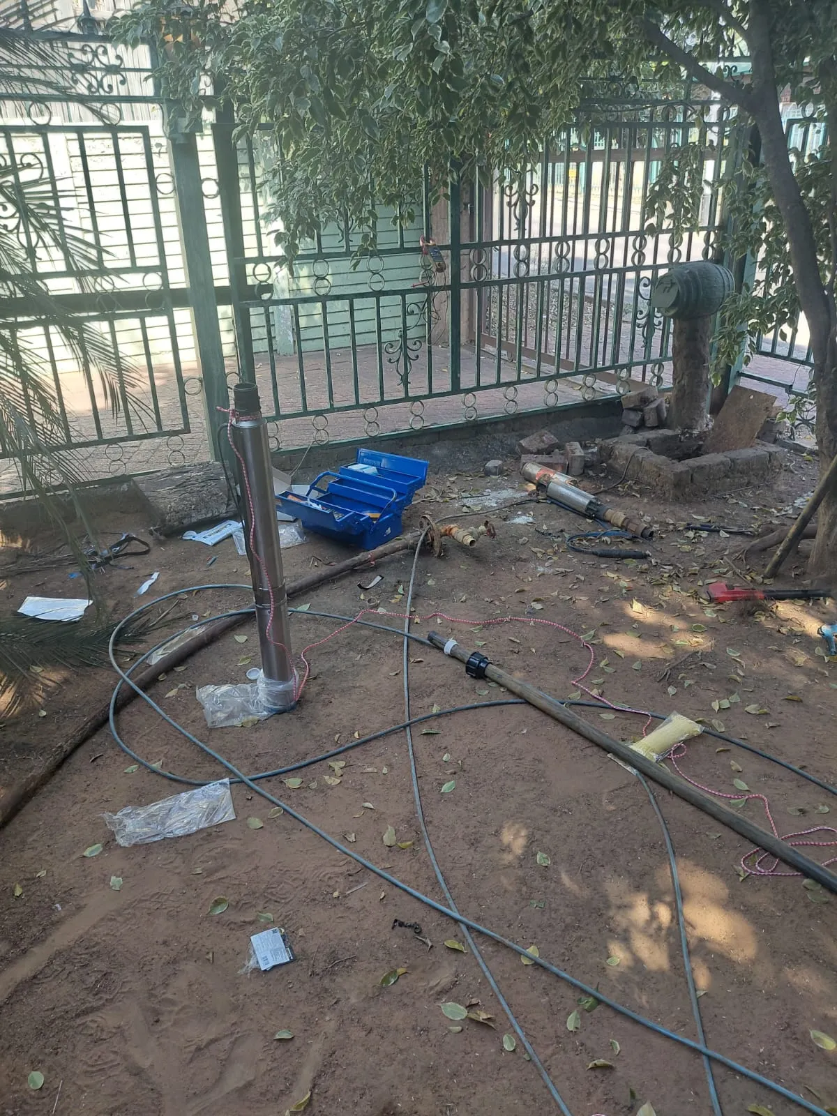 Borehole casing with cables and pipes during installation